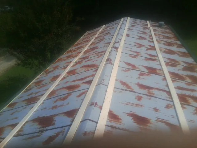 Rusted metal roof panels with new wood purlins before replacement — Storm Damage Roof Repair in Starlight by Roofing Brothers