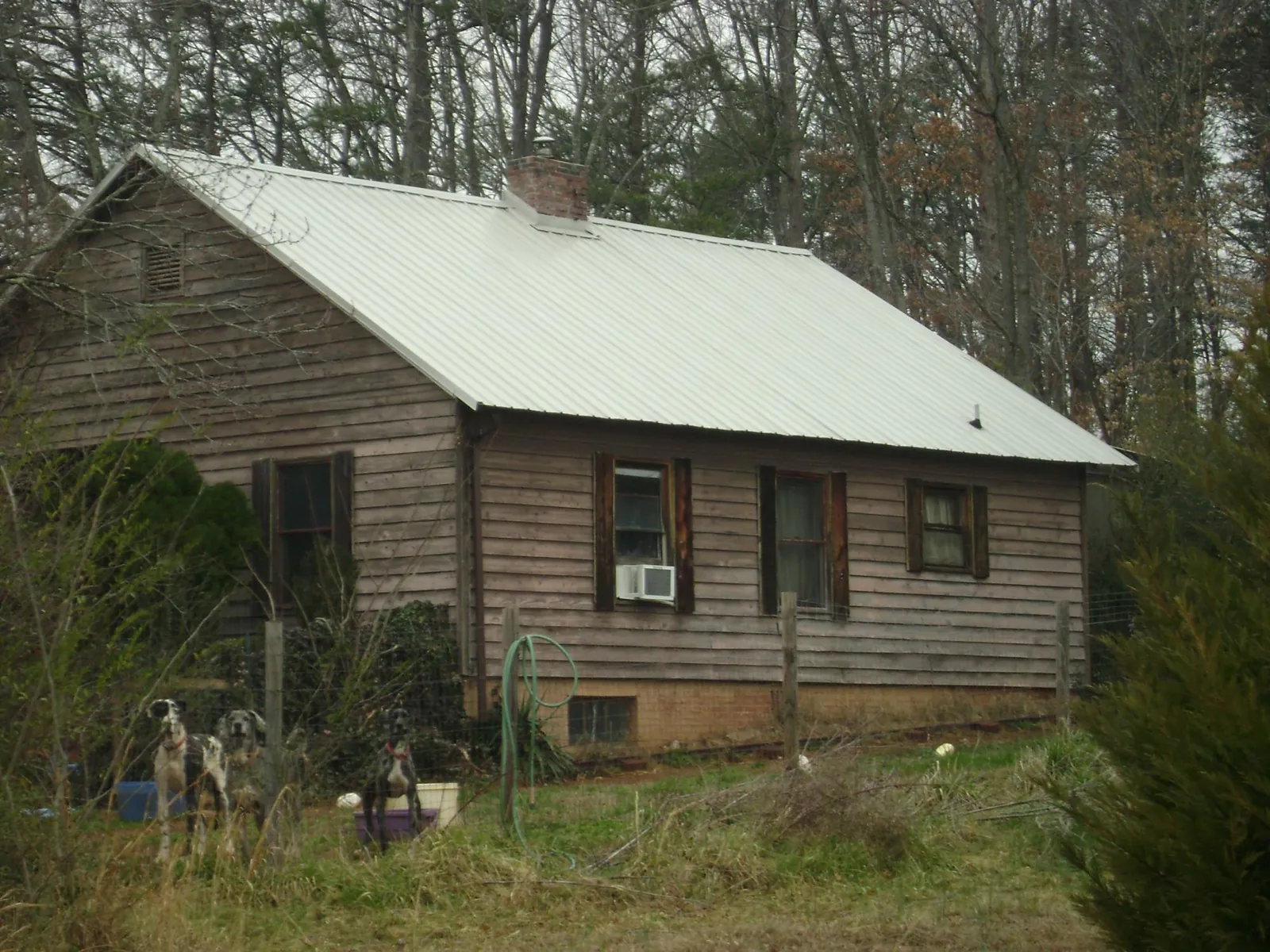 White metal roof on an old wood sided farmhouse, from a Metal Roof Installation job in Starlight
